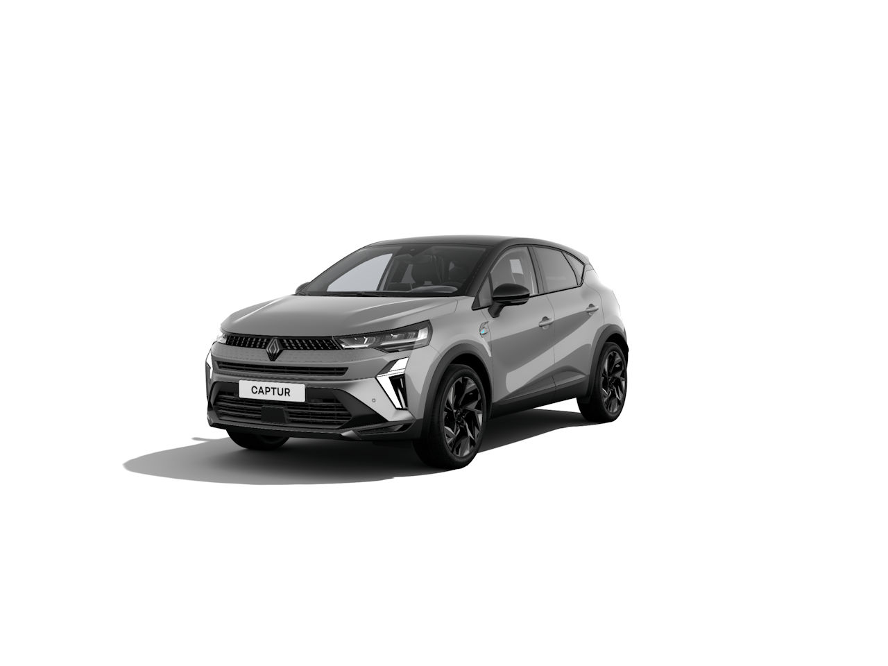 Renault Captur in Grau mit schwarzem Dach, frontal sichtbar auf weißem Hintergrund.
