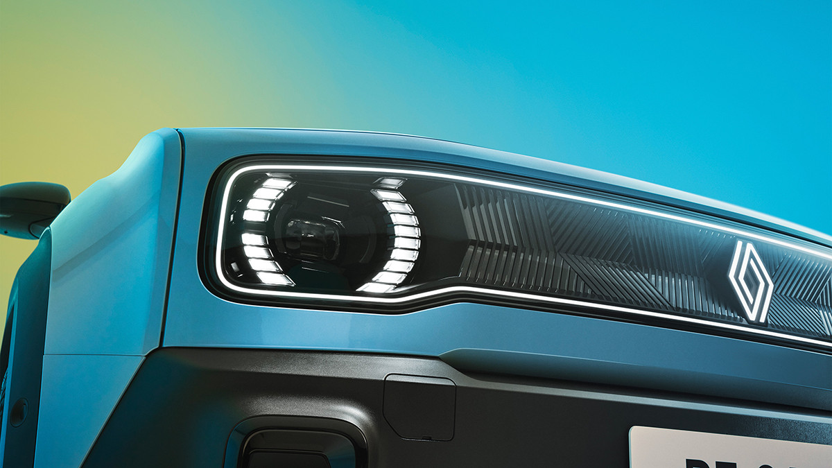 Detailaufnahme des Scheinwerfers eines blauen Renault-Autos auf einem farbenfrohen Hintergrund.
