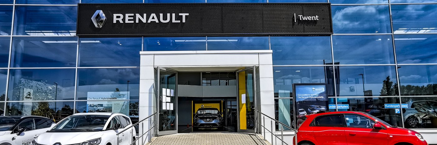 Renault Autohaus mit Glasfassade und mehreren Fahrzeugen, darunter ein rotes Auto, Standort Twent.