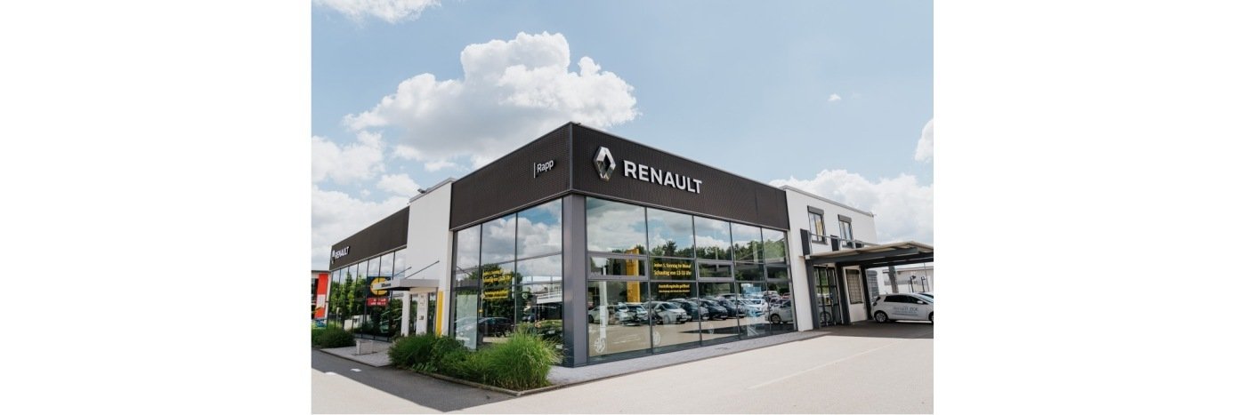 Renault Autohaus mit modernem Design und großen Fenstern, in einem hellen, sonnigen Umfeld.